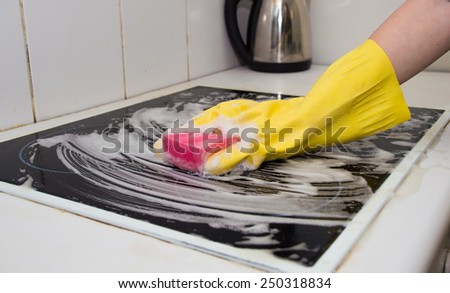 hand washes the plate in the kitchen