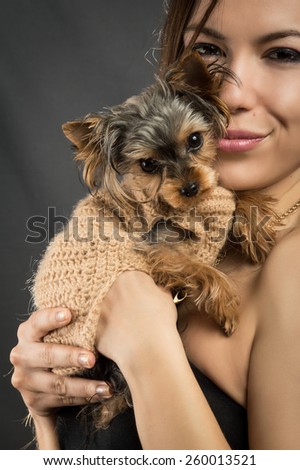 Glamour girl with a dog on a gray background York