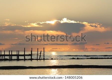 Sunrise over a Wooden Pier - Fiery sunrise over a wooden pier at a tropical resort in the Mayan Riviera, Mexico.