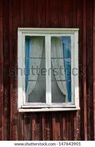 Old window with curtains, typical Swedish style
