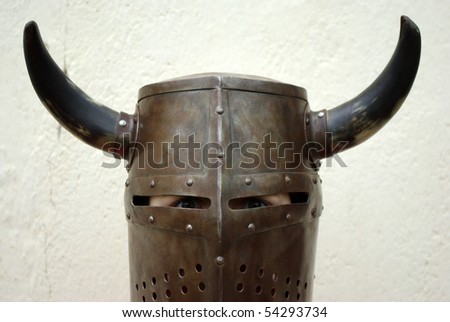 Closeup shot of a boy dressed up on a medieval knight helmet with horns