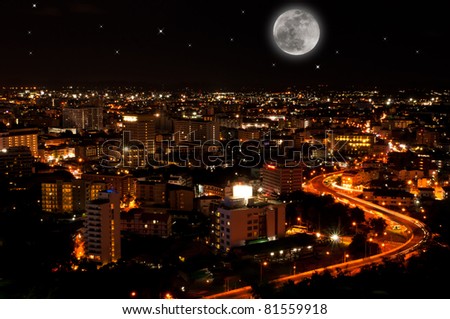 a curve road in Pattaya city at night time with the big full moon, famous place in thailand