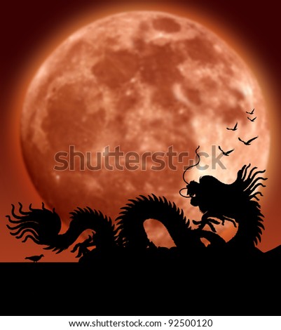 Dragon over the roof with orange big moon