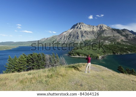 Woman Photographer on Hill Overlooking Waterton Lakes - Waterton Lakes National Park, Alberta, Canada