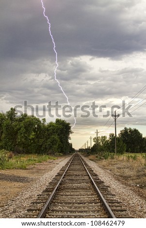 Late afternoon thunderstorms came rolling in and caught this lightning bolt striking next to the railroad track.