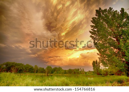 Scenic landscape view at Pella Ponds in Boulder County Colorado with an apocalyptic sunset colorful angry sky.