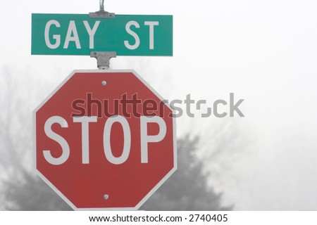 Green Gay Street sign with a red stop sign.