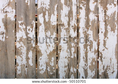 Old Wood Fence with massive chipped peeling white paint texture background.