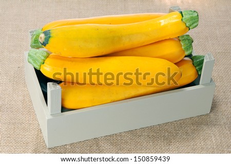 yellow zucchini in crate on table