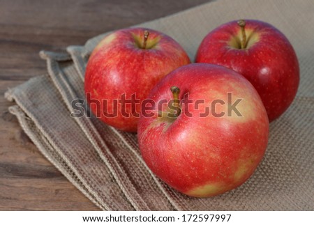 three gala apples on napkin on the table