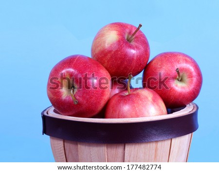 gala apple falling full of bucket on table