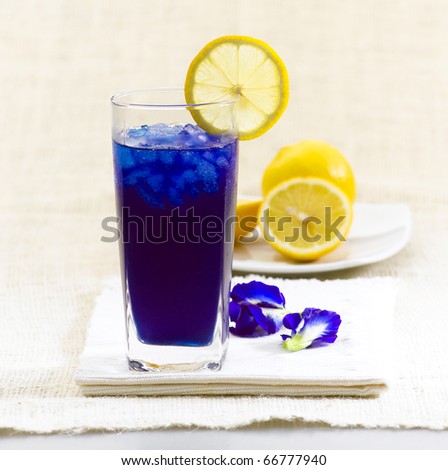 Butterfly pea Thai herb drink with lemon for health in cold glass, an image isolated