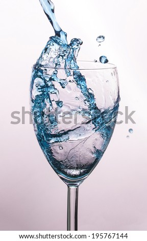 Beautiful splash of water in glass isolated on white