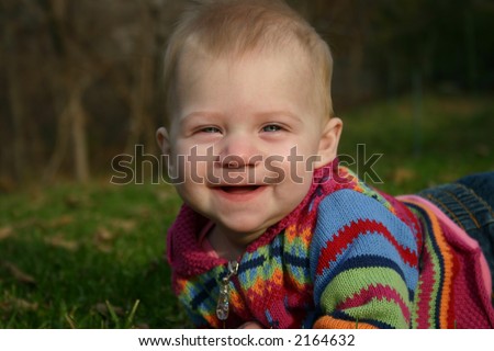Adorable six month old baby with toothless smile