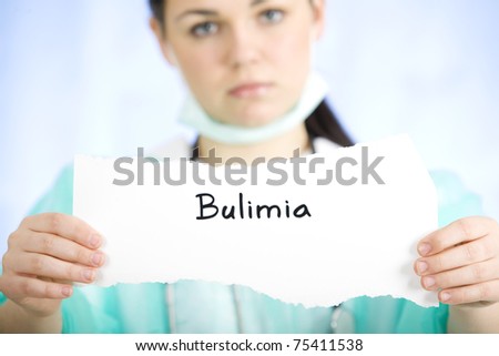 Doctor holding a paper sign with a message