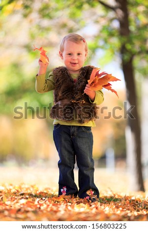 cute little girl with fall leaves