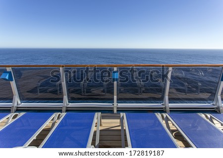 Lounge chairs on deck of luxury cruise ship