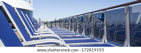 Lounge chairs on deck of luxury cruise ship