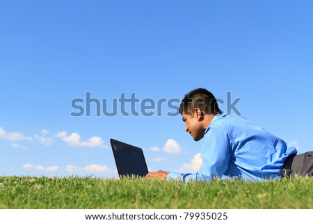 businessman working with laptop at the park
