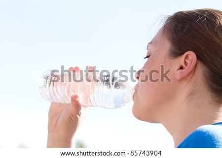 young woman drinking water from bottle
