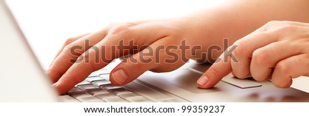 hands on laptop keyboard