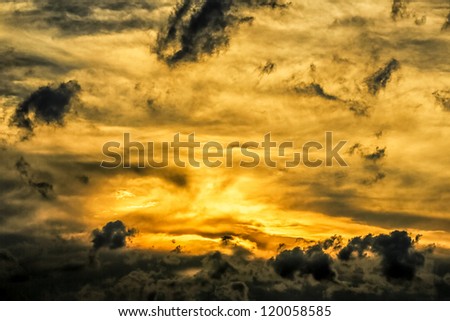 Beautiful golden sun setting behind the dark stormy clouds over the skies of Johannesburg city