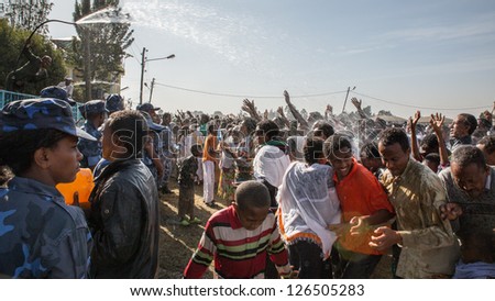 ADDIS ABABA, ETHIOPIA - JANUARY 19: Holy water sprayed on thousands of people attending Timket celebrations of Epiphany, commemorating the baptism of Jesus, on January 19, 2013 in Addis Ababa, Ethiopia.