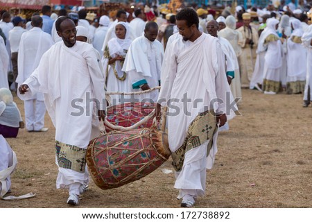 Addis Ababa - Jan 18: Clergymen carry a kebero, a traditional drum made out of animal hide, in preparation for Timket celebrations of Epiphany, on January 18, 2014 in Addis Ababa.
