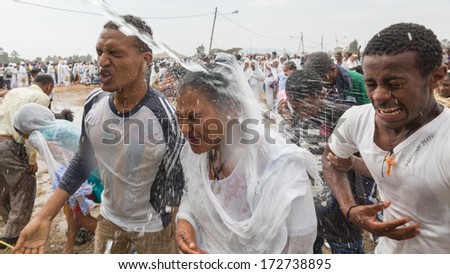 Addis Ababa - Jan 19: Holy water is sprayed onto the crowd attending Timket celebrations of Epiphany, commemorating the baptism of Jesus, on January 19, 2014 in Addis Ababa.