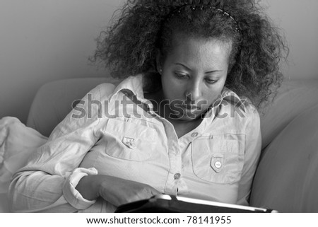 A black Ethiopian woman studying on her tablet PC.