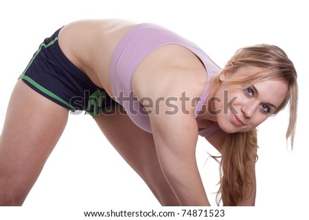 A physically fit girl is stretching before some exercise.