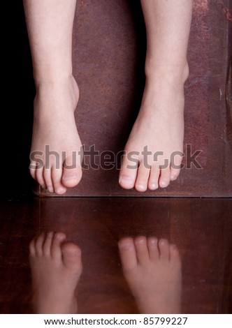 A cute symbolic image of two feet and there reflection.