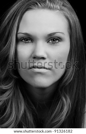 A close up black and white image of a beautiful woman with amazing hair.