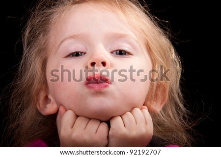 Image of a girl with her tongue sticking out.