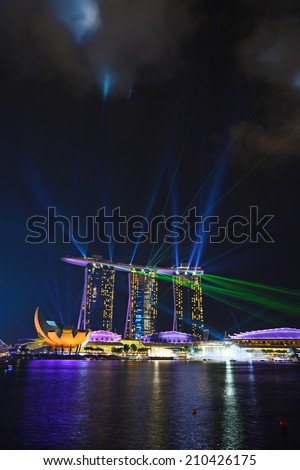 SINGAPORE - JUN 27: The laser show at the Marina Bay Sands on June 27, 2014 in Singapore. It is a 15 minute show from the unique ship-like rooftop of the Marina Bay Sands.