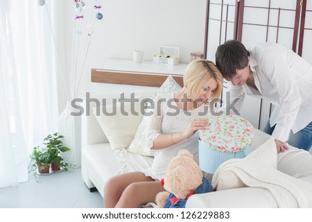 Pregnant woman with her husband at home for Christmas
