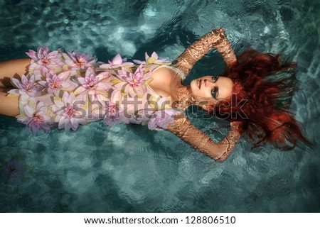 portrait of beautiful red-haired girl in the water