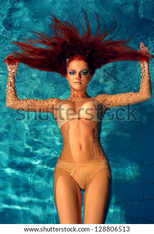 portrait of beautiful red-haired girl in the water