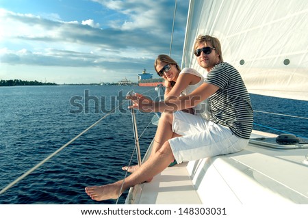 Happy young couple relaxing on a yacht Happy young couple relaxing on a yacht