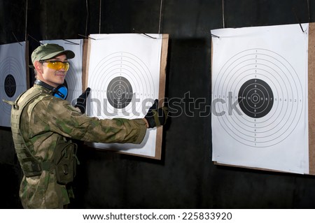 Man with target in shooting range