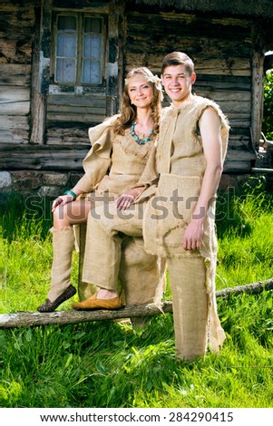 Ancient Medieval couple in original costumes from gunny sacking