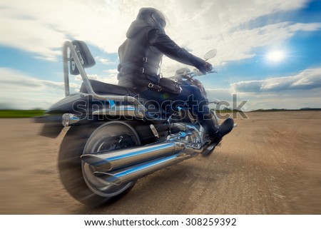 Biker man riding on a motorcycle. Bottom view