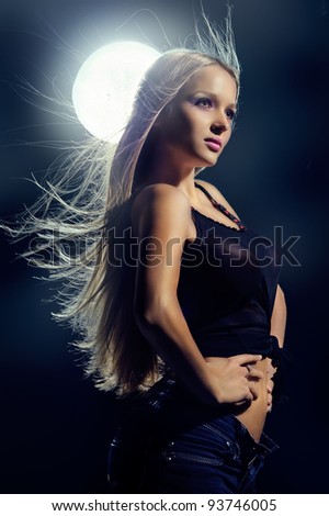 mysterious girl in modern dress with the moon in the background
