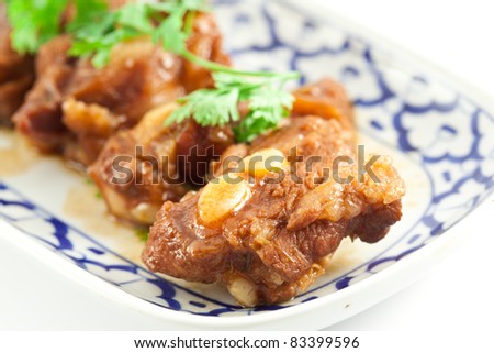 close up Pork rib roast with a sweet sauce on a white plate
