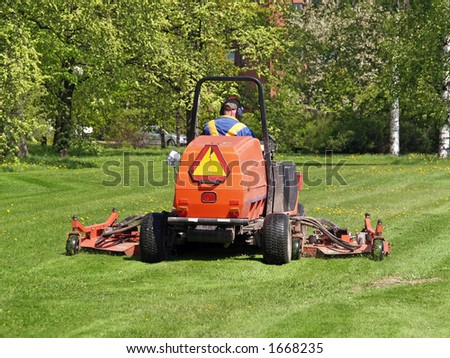 Grass cutting tractor in action