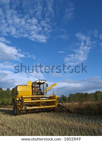 Harvester-thresher rests after work, at sunset