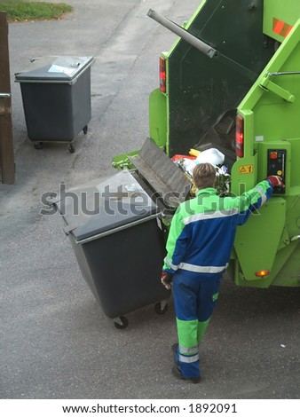 Rubbish collecting machine operator empties boxes, close-up
