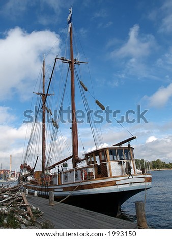 Wooden ship docked in a harbor, view