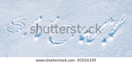 text SNOW! written on a pure snow field