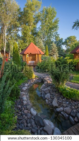 Gazebo in landscaped garden with interlocking stone patio